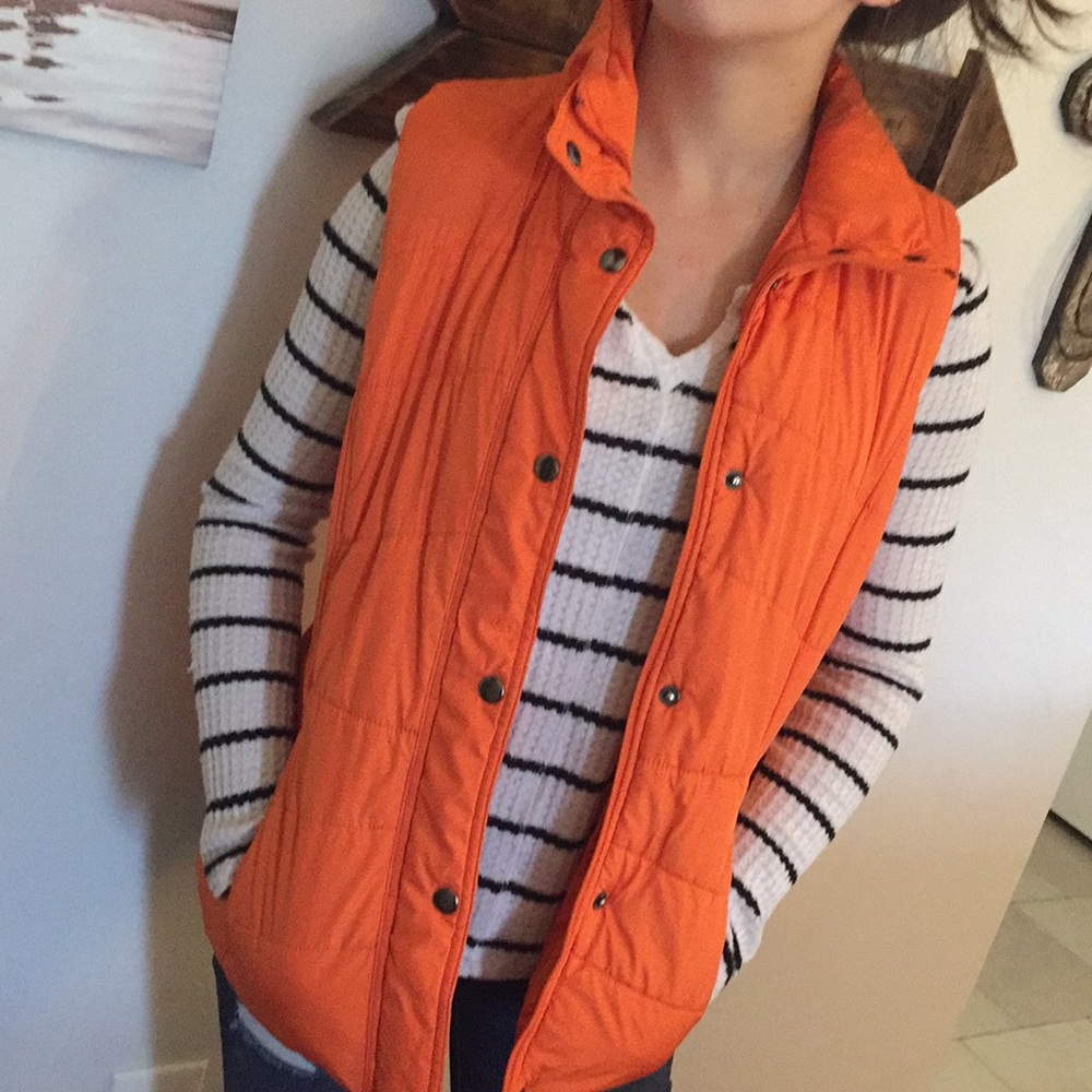 Orange zip up vest.